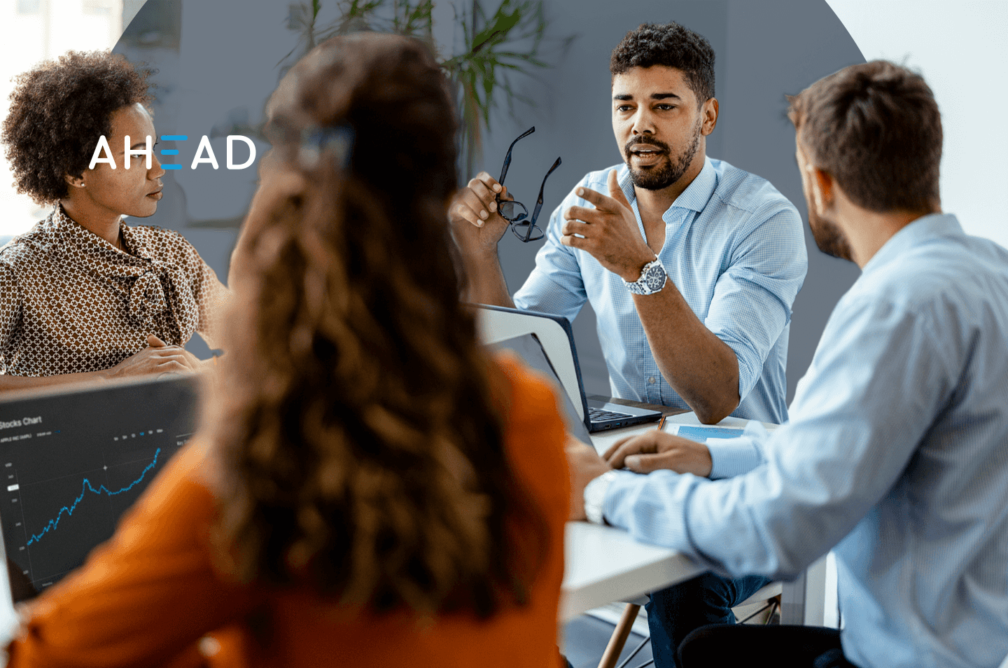 Four people sitting around a conference room table
