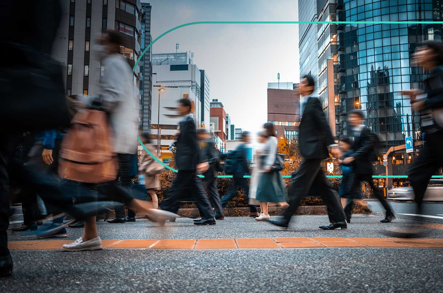 A low shot of people walking across a city street, with motion blur