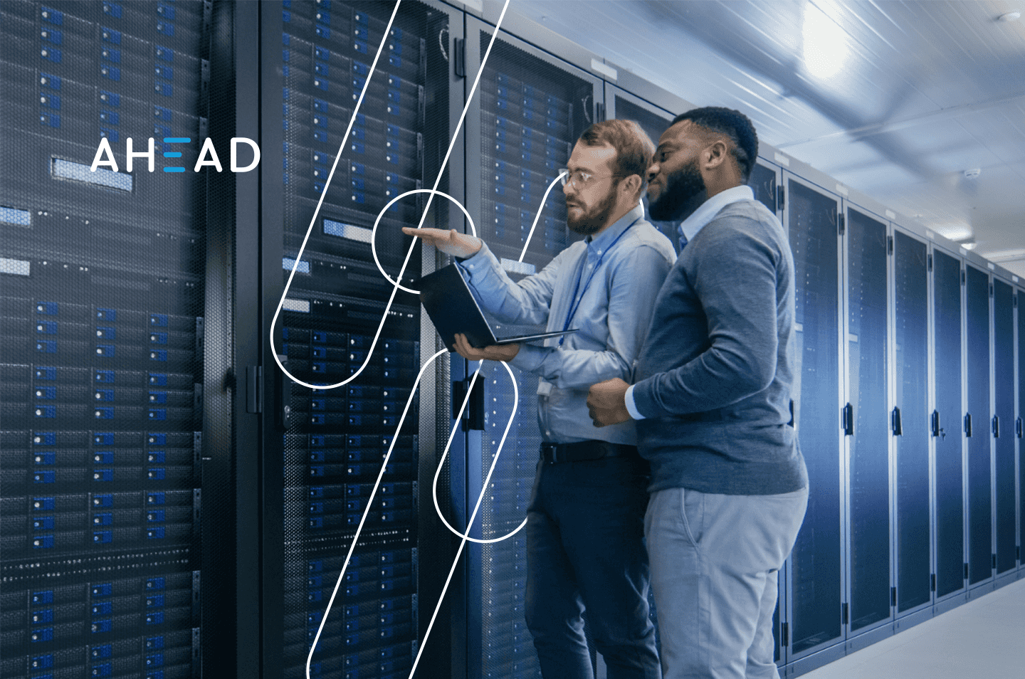 two men standing in a data center looking at racks