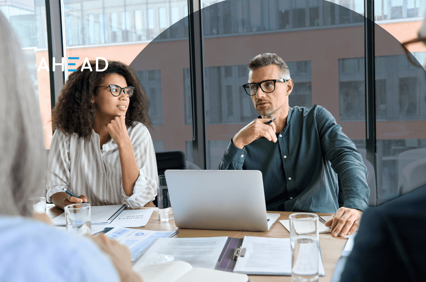 Two people sitting around a conference room table