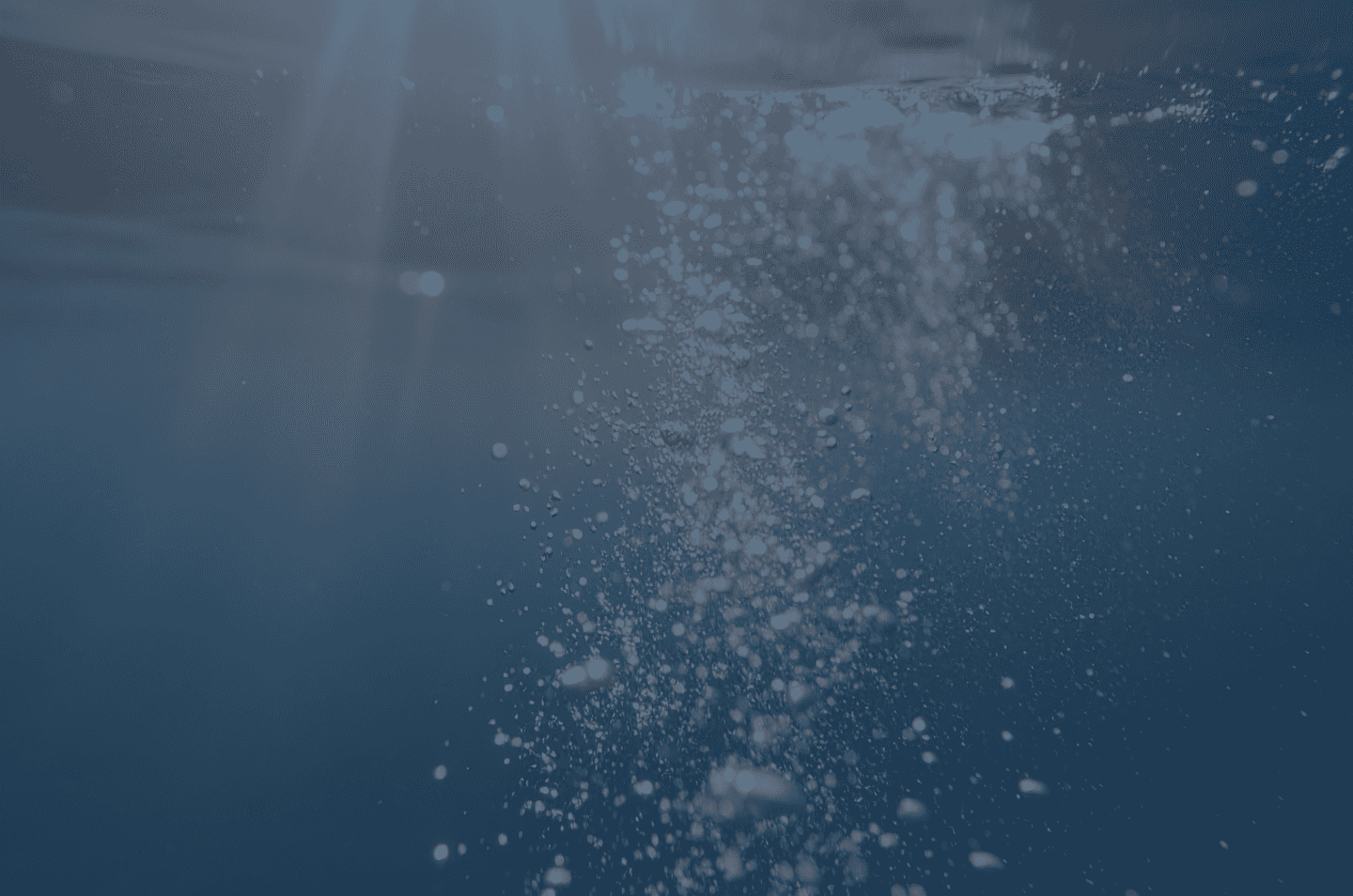 an underwater image of bubbles rising to the surface
