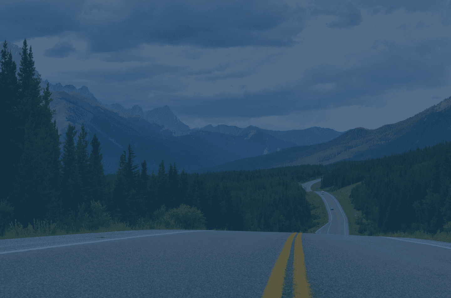 a landscape view from a road with a blue overlay over the image
