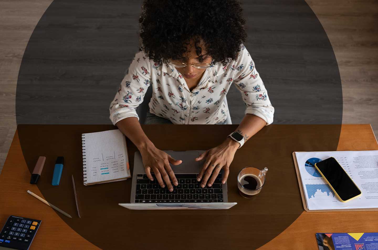 woman sitting at a desk working on a laptop