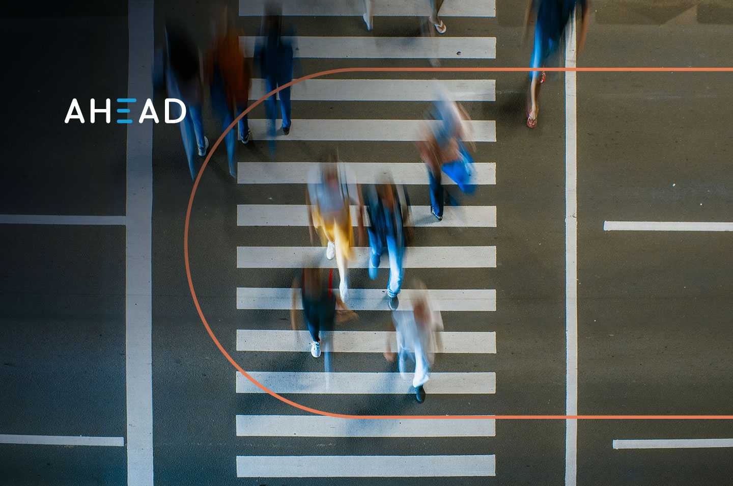 an arial view of people crossing at a crosswalk with motion blur
