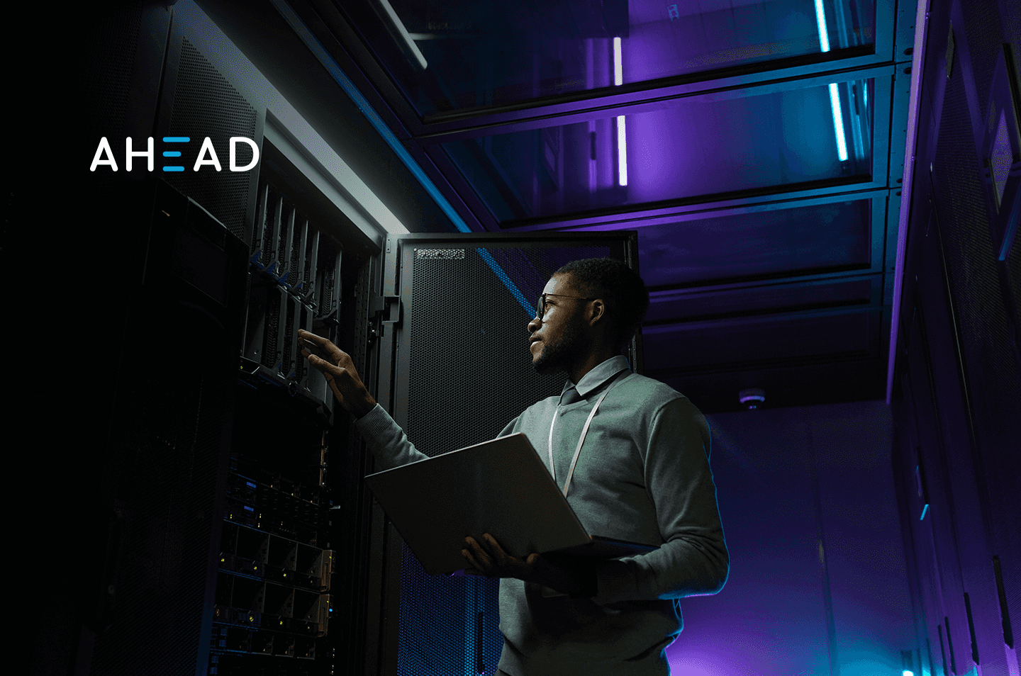 a man standing in front of data center racks