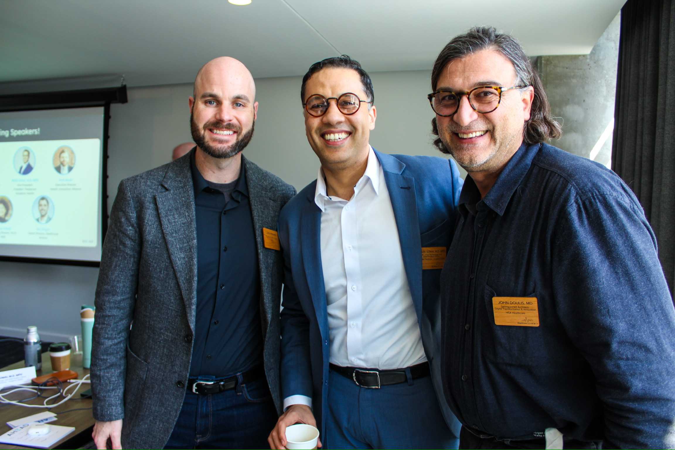 Three men posing for a photo and smiling